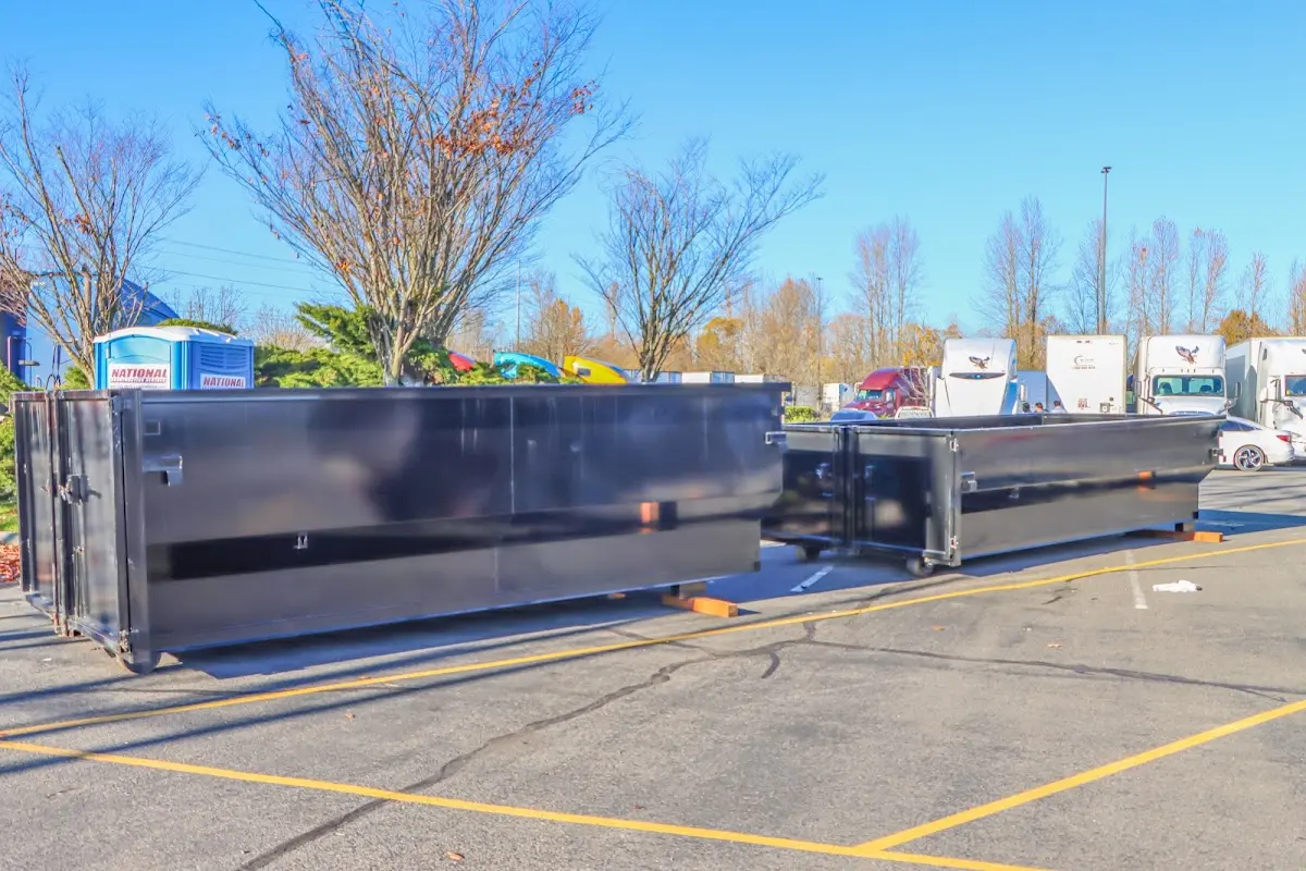 Professional dumpster rental service with roll-off container on residential driveway in Sylvester